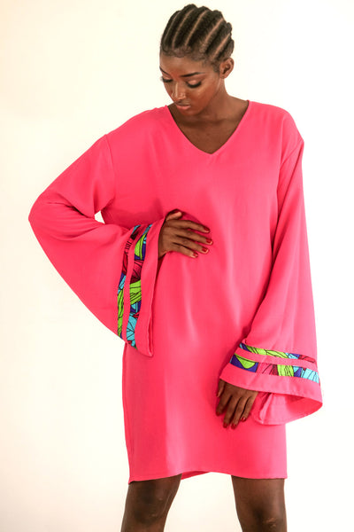 Pink Kaftan with strips of African print wax on an exaggerated sleeve. It is so easy to throw one on and get on with the day