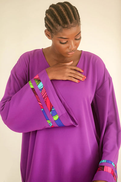 Purple Kaftan with strips of African print wax on an exaggerated sleeve. It is so easy to throw one on and get on with the day