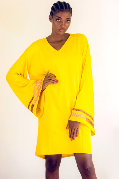 Yellow Kaftan with strips of African print wax on an exaggerated sleeve. It is so easy to throw one on and get on with the day